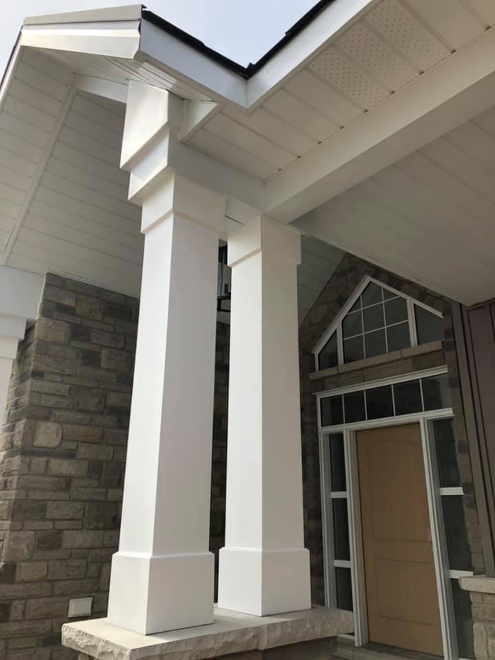 A porch with columns and a door.